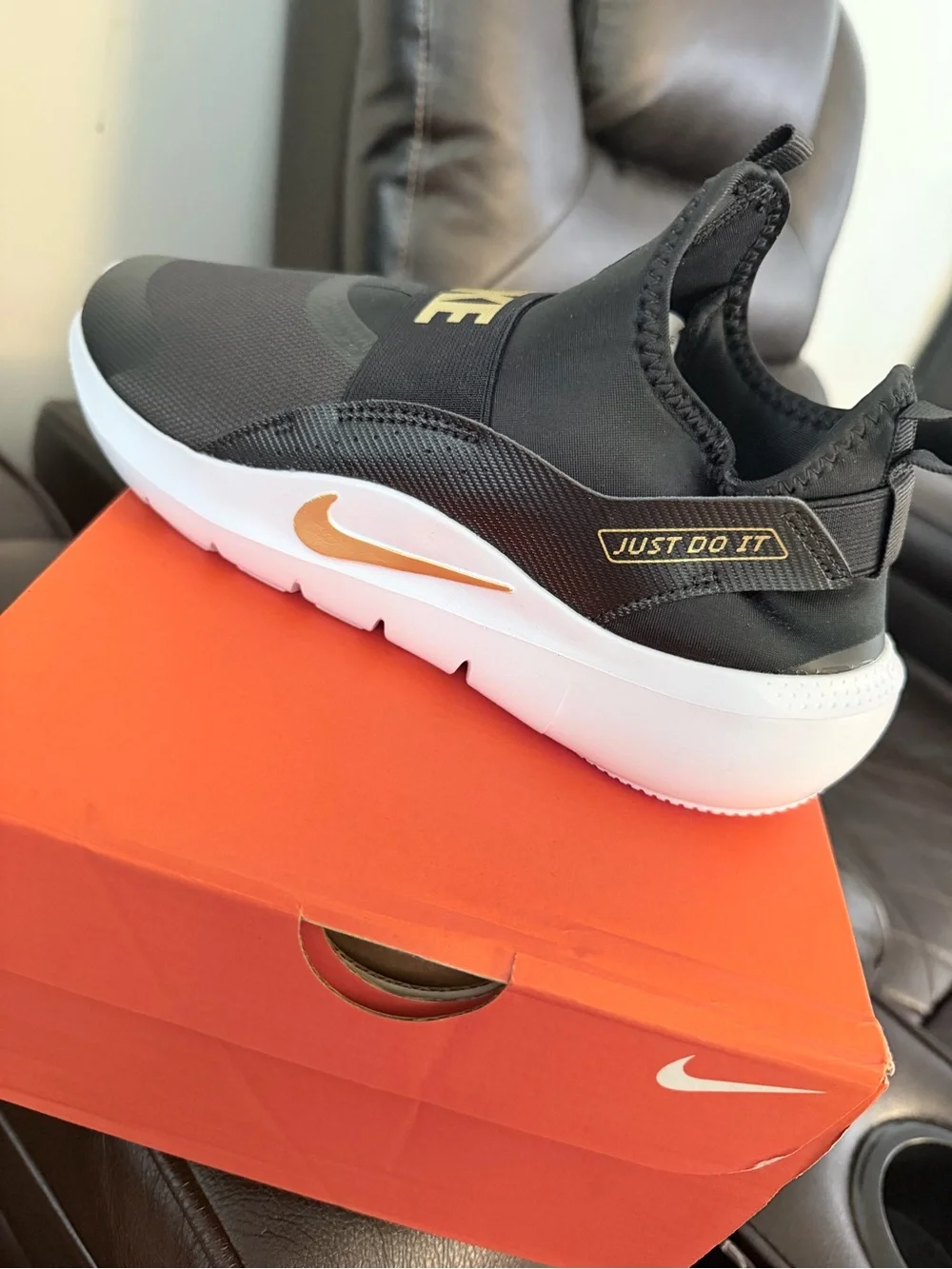 Nike Men’s Slip-On Sneakers in Black and Gold Accent